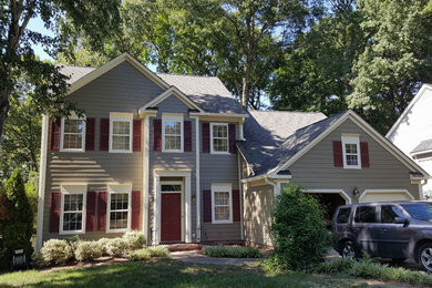 Inspiration for a large timeless gray two-story vinyl gable roof remodel in Charlotte