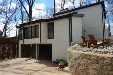 Minimalist beige two-story concrete fiberboard house exterior photo in Atlanta