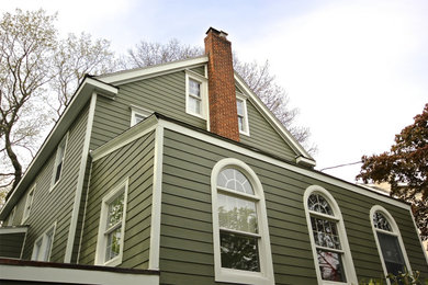 Mid-sized farmhouse green two-story mixed siding exterior home photo in Chicago with a shingle roof