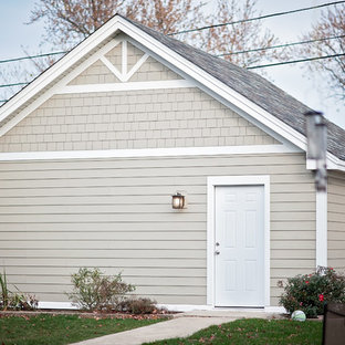 Example of a large arts and crafts beige two-story concrete fiberboard exterior home design in Chicago with a shingle roof