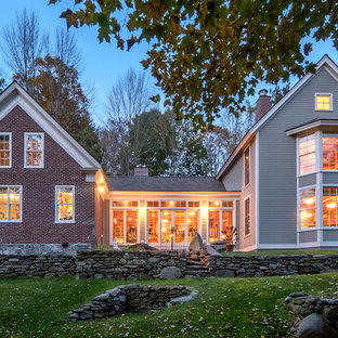 Contemporary gray brick gable roof idea in Burlington