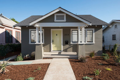 Inspiration for a medium sized and green traditional bungalow house exterior in Los Angeles with wood cladding.
