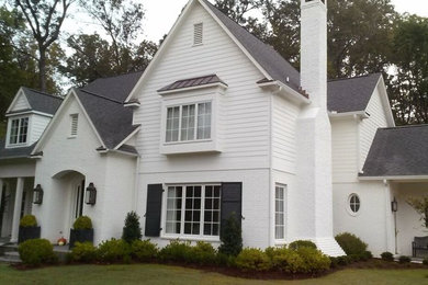 Idée de décoration pour une façade de maison blanche tradition en bois de taille moyenne et à un étage avec un toit à deux pans.
