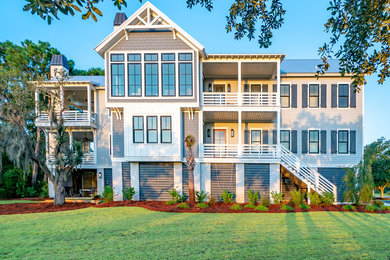 Large cottage gray three-story wood exterior home photo in Charleston with a metal roof