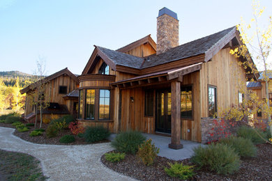 Inspiration for a large rustic brown two-story wood exterior home remodel in Other with a shingle roof