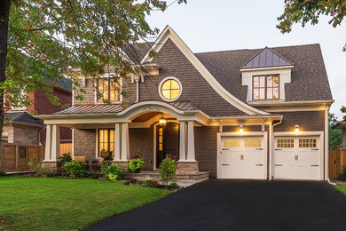 Large arts and crafts brown two-story wood house exterior photo in Toronto with a hip roof and a mixed material roof