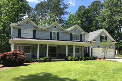 Inspiration for a large timeless blue two-story wood exterior home remodel in Atlanta with a hip roof