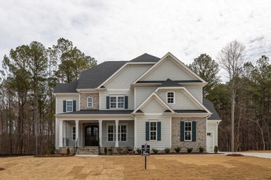 Mid-sized elegant gray three-story house exterior photo in Raleigh