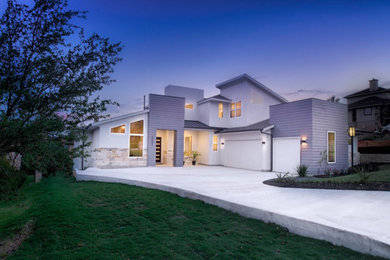 Example of a large minimalist gray vinyl exterior home design in Austin
