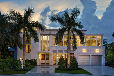 Example of a huge trendy beige split-level mixed siding flat roof design in Miami
