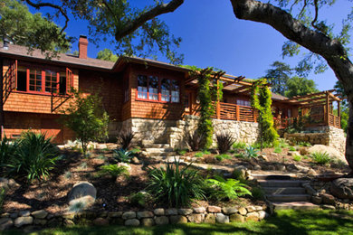 Inspiration for a large brown one-story wood exterior home remodel in Santa Barbara with a hip roof