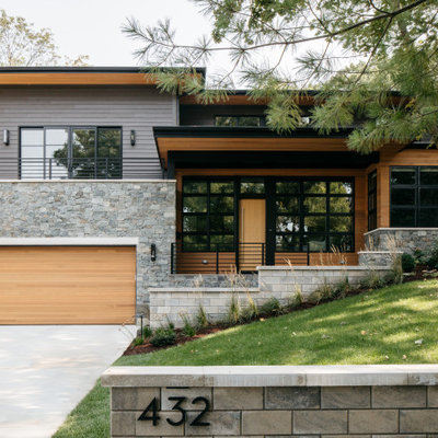 Contemporary two-story mixed siding house exterior idea in Chicago with a hip roof