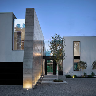 Gey contemporary render detached house in Manchester with a flat roof.
