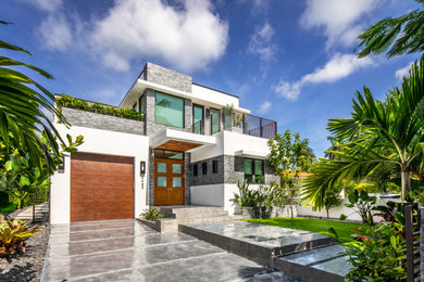 Inspiration for a large contemporary white two-story stucco exterior home remodel in Miami