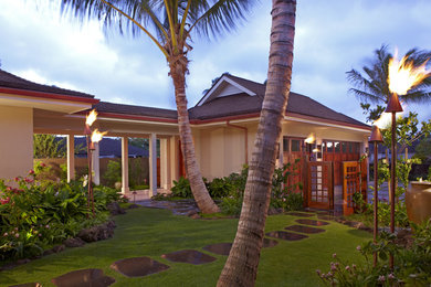 Large tropical beige two-story stucco exterior home idea in Hawaii
