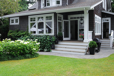 Example of a mid-sized arts and crafts gray two-story wood exterior home design in Vancouver