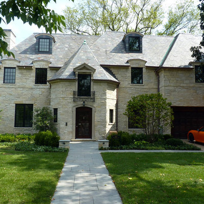 Example of a large classic three-story stone exterior home design in Chicago