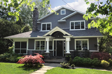Example of a mid-sized classic gray two-story vinyl exterior home design in New York with a shingle roof