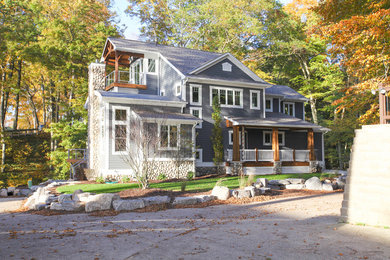 Photo of a gey farmhouse house exterior in Grand Rapids with three floors.