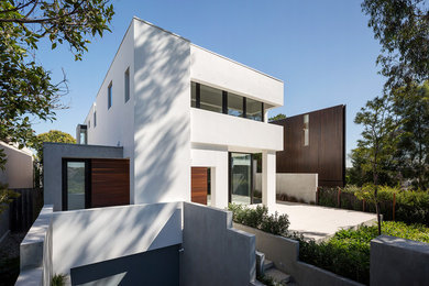 Large trendy white two-story concrete exterior home photo in Melbourne