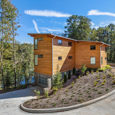 Rustic wood house exterior idea in Other with a shed roof