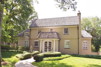 Large tuscan beige three-story stucco exterior home photo in Philadelphia