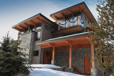 Example of a large transitional gray two-story stone flat roof design in Vancouver