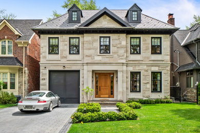 Inspiration for a timeless two-story stone house exterior remodel in Toronto with a hip roof and a tile roof