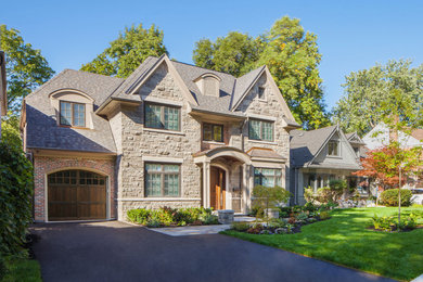 Inspiration for a mid-sized timeless beige two-story stone exterior home remodel in Toronto with a shingle roof