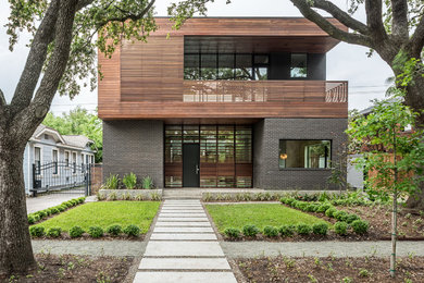 Contemporary two-story mixed siding flat roof idea in Houston