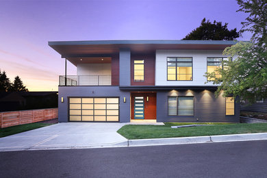 Example of a large trendy blue two-story mixed siding exterior home design in Seattle
