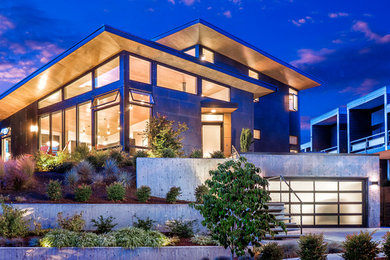 Mid-sized trendy gray two-story concrete fiberboard house exterior photo in Seattle with a hip roof