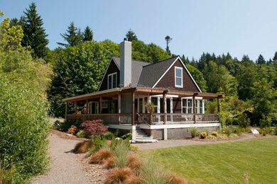 Inspiration for a transitional brown two-story wood exterior home remodel in Seattle with a hip roof
