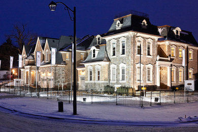 Example of a large beige two-story stone exterior home design in Toronto