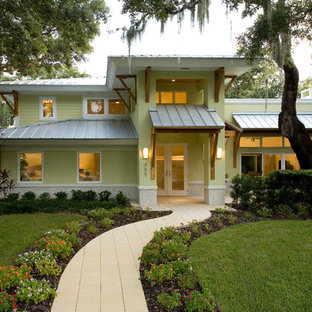 Example of an island style yellow two-story exterior home design in Tampa