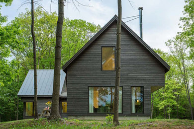 Inspiration for a mid-sized contemporary brown two-story wood exterior home remodel in Burlington with a metal roof