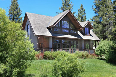 Example of a mid-sized mountain style gray two-story concrete exterior home design in Other with a shingle roof