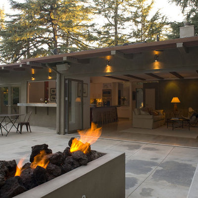 Example of a large trendy gray one-story stucco flat roof design in Los Angeles
