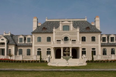 Cette image montre une très grande façade de maison grise traditionnelle à deux étages et plus avec un toit en shingle.