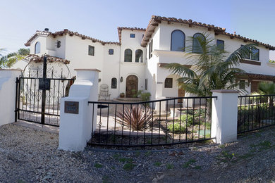 Example of a large tuscan white two-story stucco exterior home design in San Diego