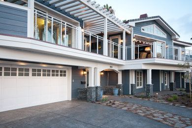 Example of a large beach style blue two-story wood exterior home design in San Diego
