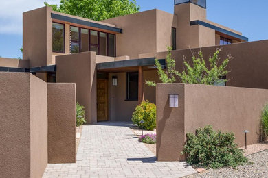 Modelo de fachada de casa marrón de estilo americano grande de dos plantas con revestimiento de estuco, tejado plano y tejado de metal