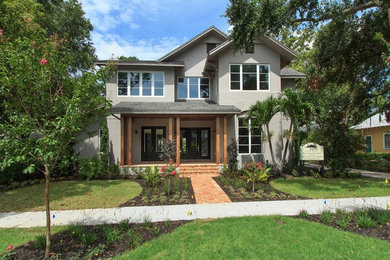 Large transitional gray two-story stucco gable roof photo in Orlando