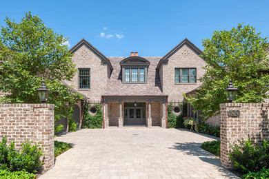 Elegant two-story brick house exterior photo with a hip roof and a tile roof