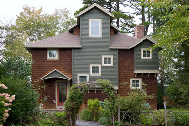 Example of a mid-sized arts and crafts brown two-story wood exterior home design in Boston with a hip roof