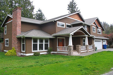 Example of a large arts and crafts brown two-story wood and clapboard house exterior design in Seattle