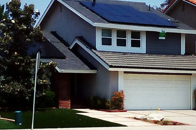 Elegant gray two-story vinyl gable roof photo in Orange County