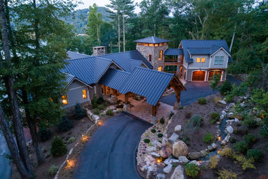 Example of a huge arts and crafts two-story exterior home design in Other with a metal roof