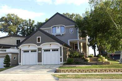 Large traditional gray two-story house exterior idea in Other with a shed roof and a shingle roof