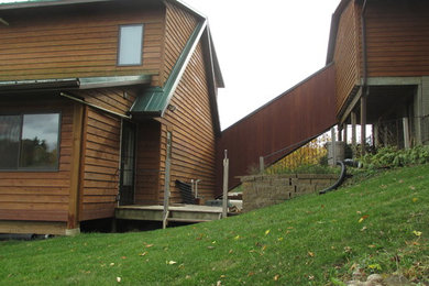 Inspiration for a large and brown traditional two floor detached house in Cedar Rapids with wood cladding, a pitched roof and a metal roof.